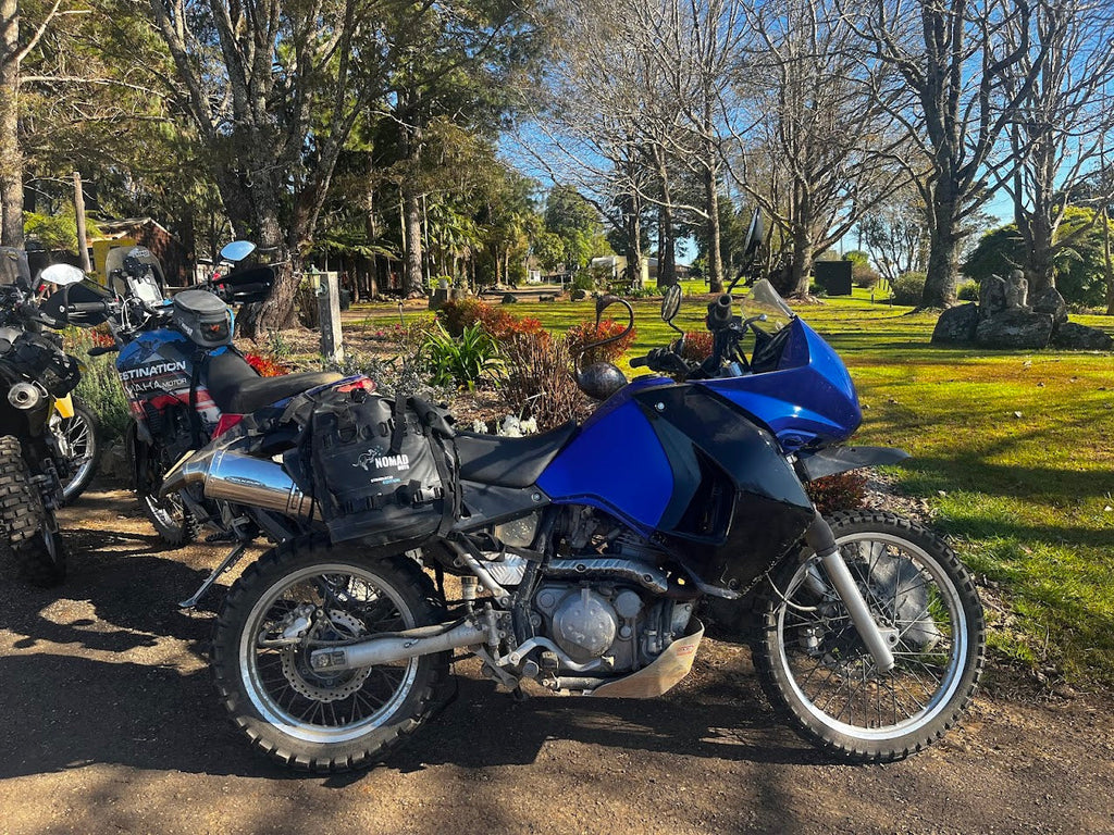 Adventure bike with soft panniers parked outside