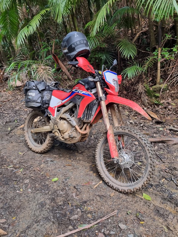Off-road motorcycle with adventure bags in the forest
