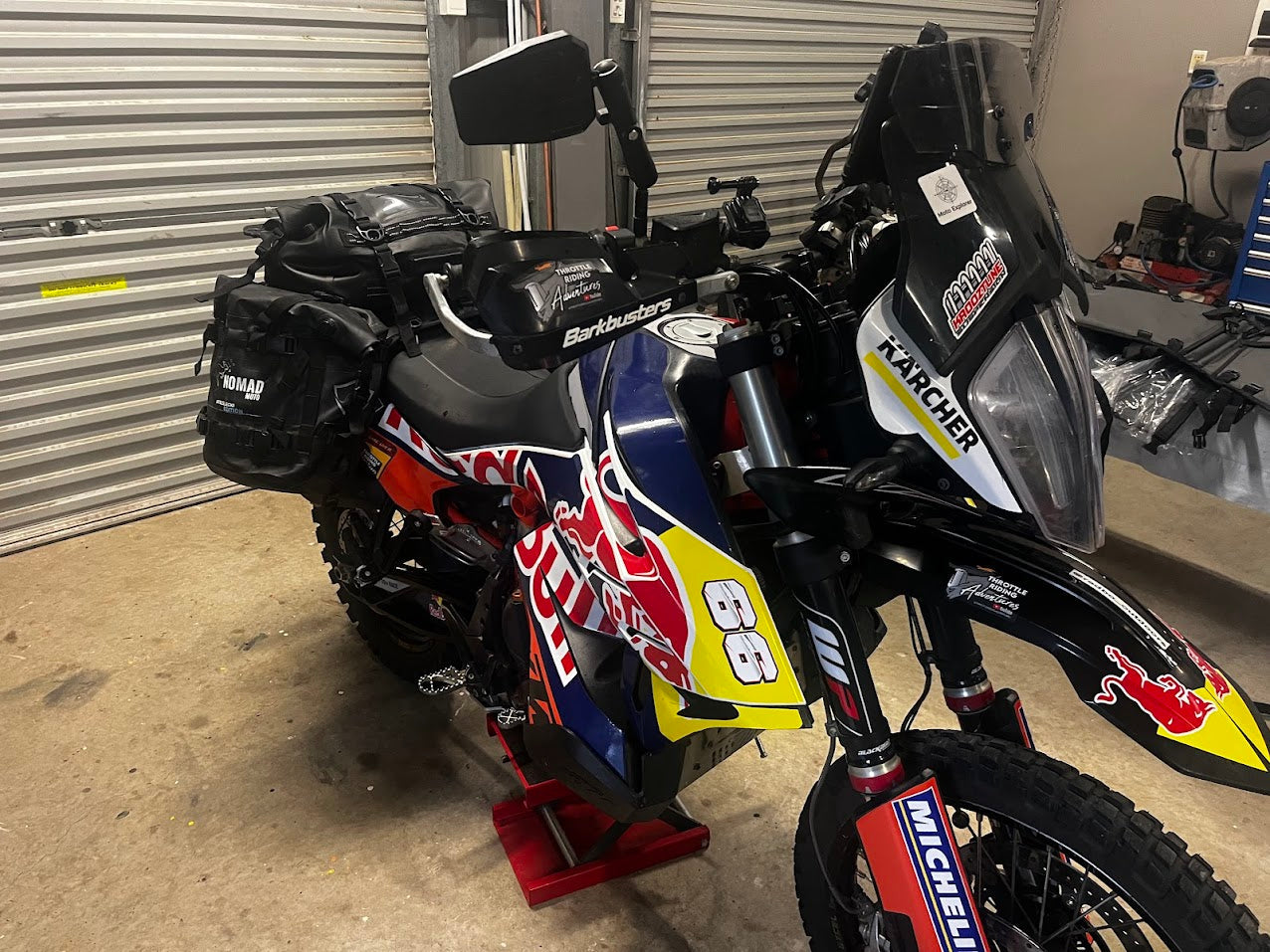 Rally bike with NOMAD MOTO soft luggage in garage