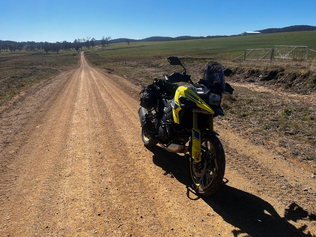 Touring motorcycle with soft luggage parked outdoors