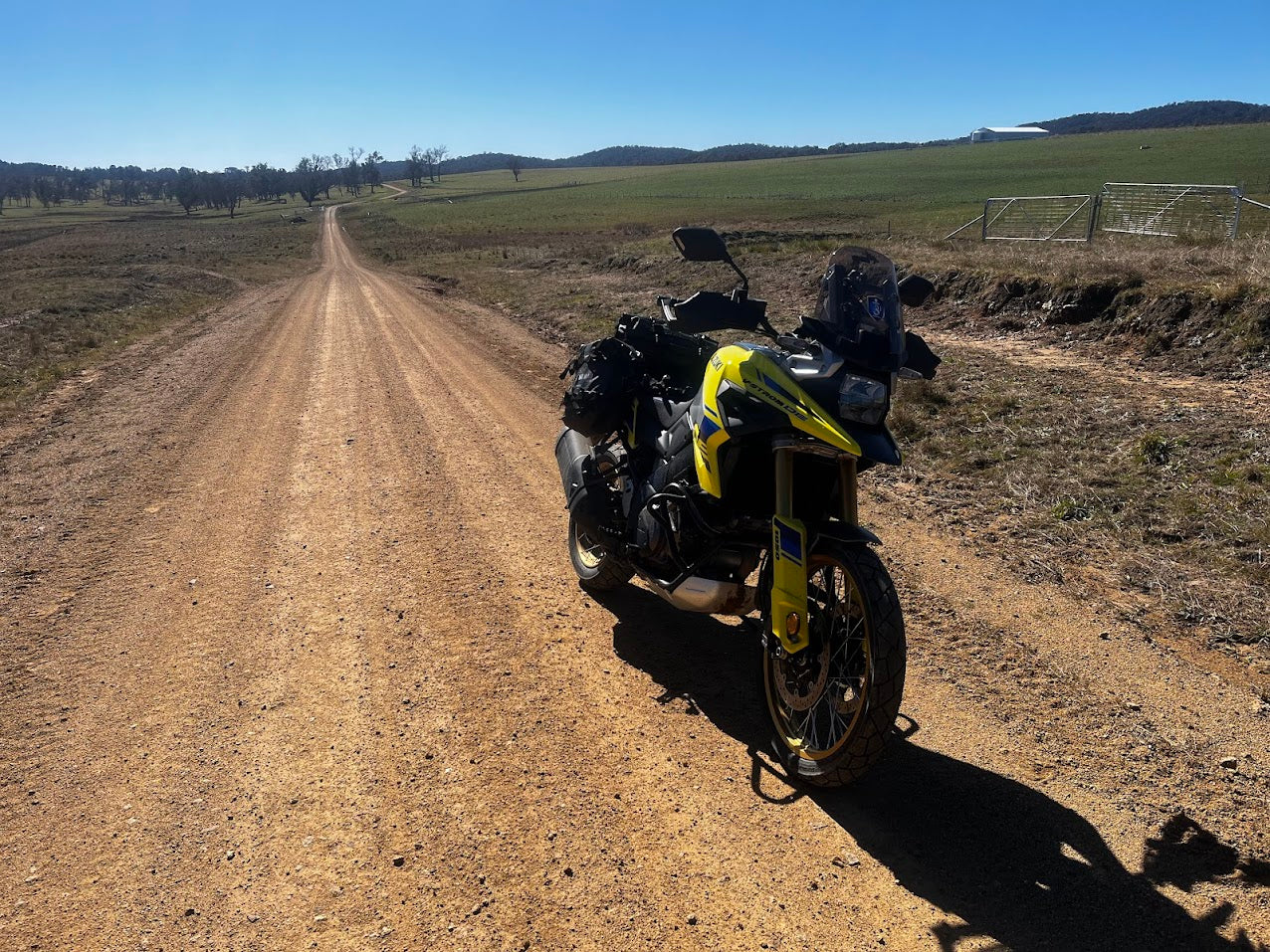 Touring motorcycle with soft luggage parked outdoors